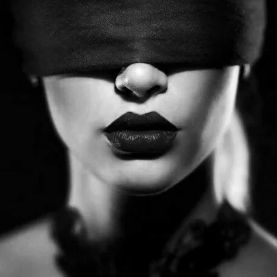 Blindfolded woman with dark lips