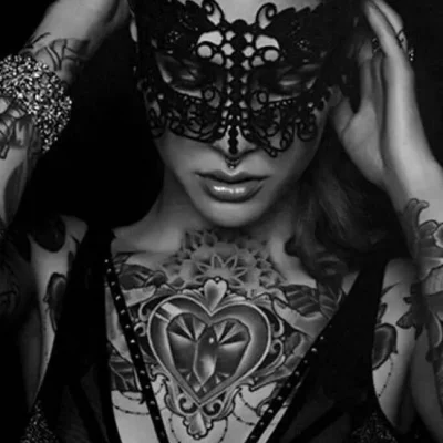 Tattooed girl with lace mask